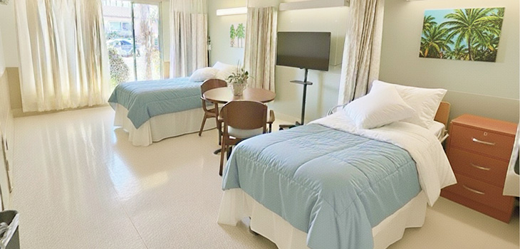 a semi-private room with light blue and white bedspreads at Pacific Palms
