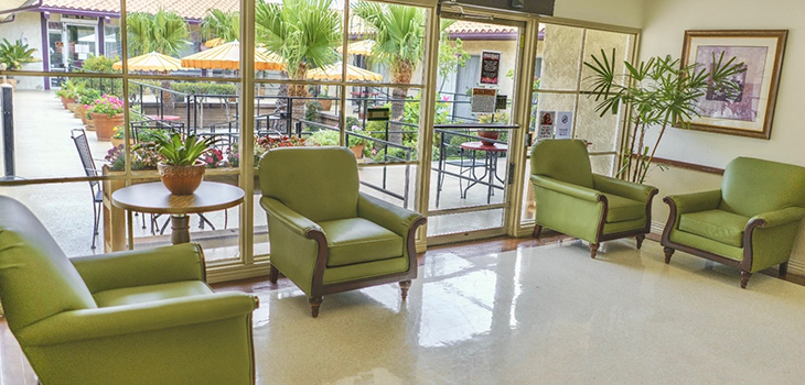 the front lobby with soft seating and glass walls at Pacific Palms