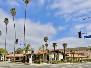 Street view of Pacific Palms with monument sign and palm trees
