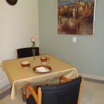 dining table set with tablecloth and fresh flowers