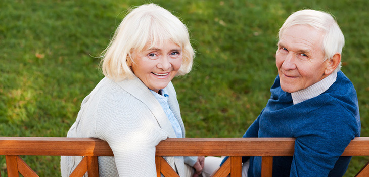 couple seated on bench outside