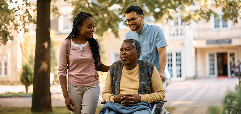 A senior man visiting with family outside