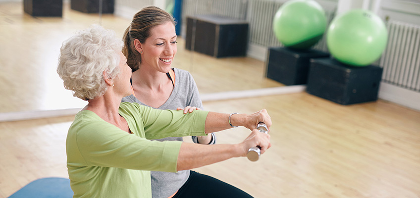 Two women working on rehabilitation exercises together.