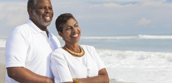 couple looking at the beach smiling
