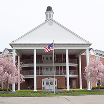 nice tall building with an american flag flying out front
