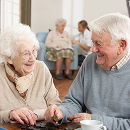 elderly couple smiling fondly at each other