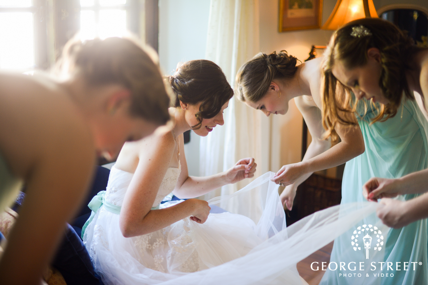 bride putting on wedding dress