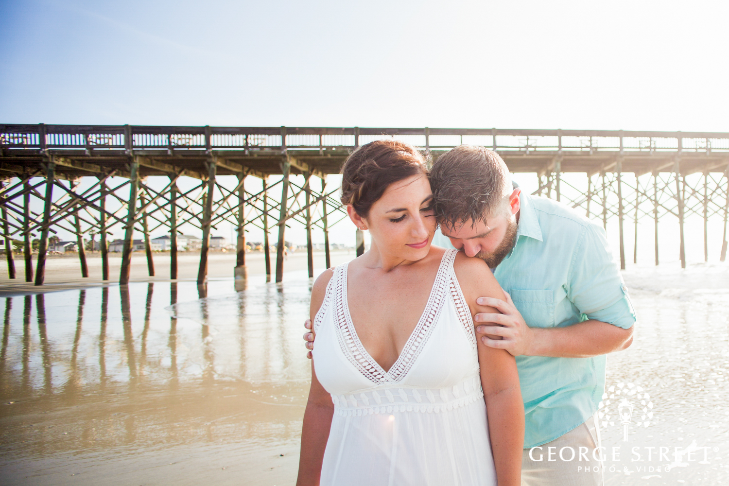 airy engagement photos on beach by pier