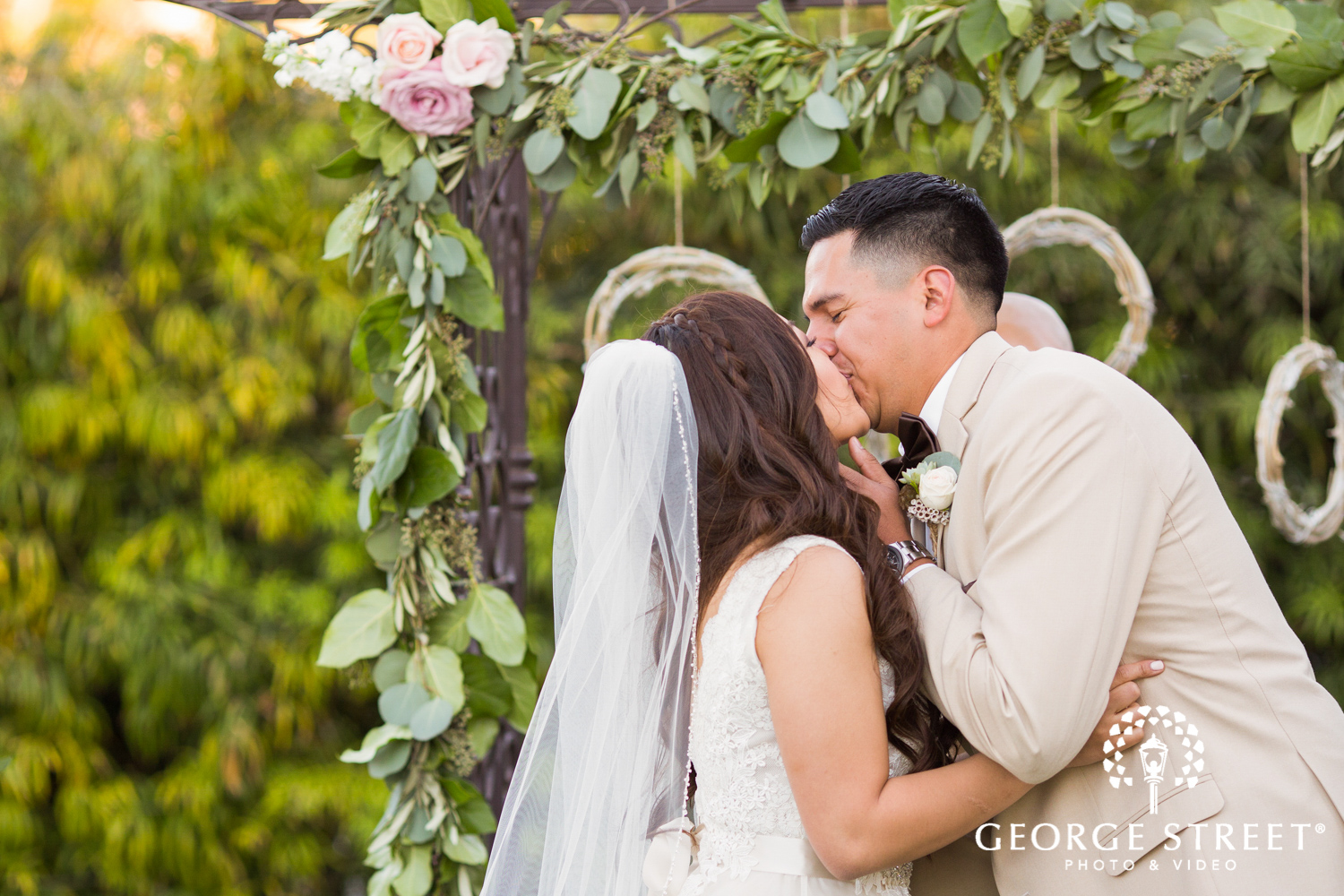 bride and groom first kiss outdoor ceremony