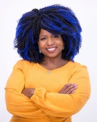 Photo of Ms Shannan, a smiling woman with blue streaks in her hair