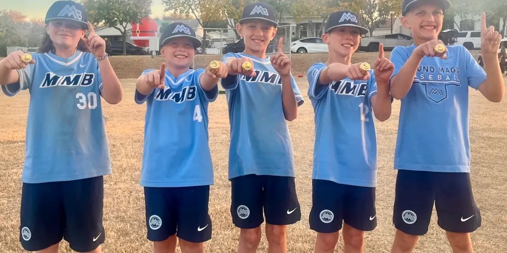 Youth baseball team celebrating with medals at Wiffletopia