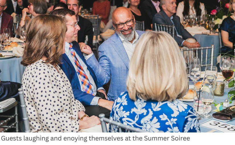 Guests laughing and enoying themselves at the Summer Soiree