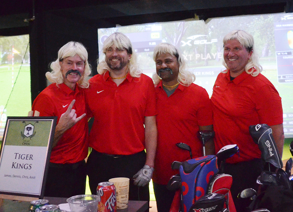 The Tiger Kings four-some at The BEF Open. Four men posing in their red polo shirts and blonde mullet wigs.