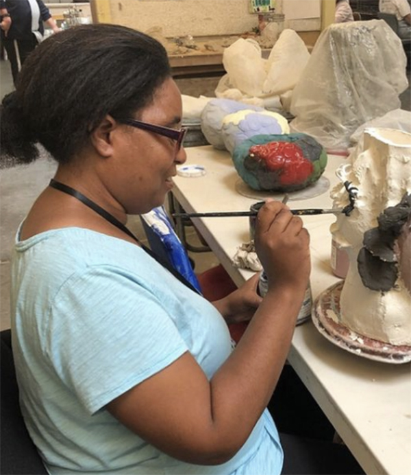 Raven Harper, NIAD Artist, creating a ceramic face vase.