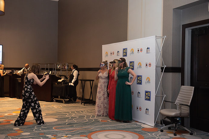 Four women pose for photos