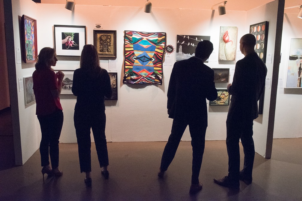 People admire art during a past One Inspired Evening at Venue West
