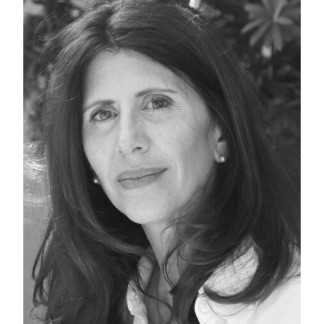 Karen smiles demurely in this black and white headshot