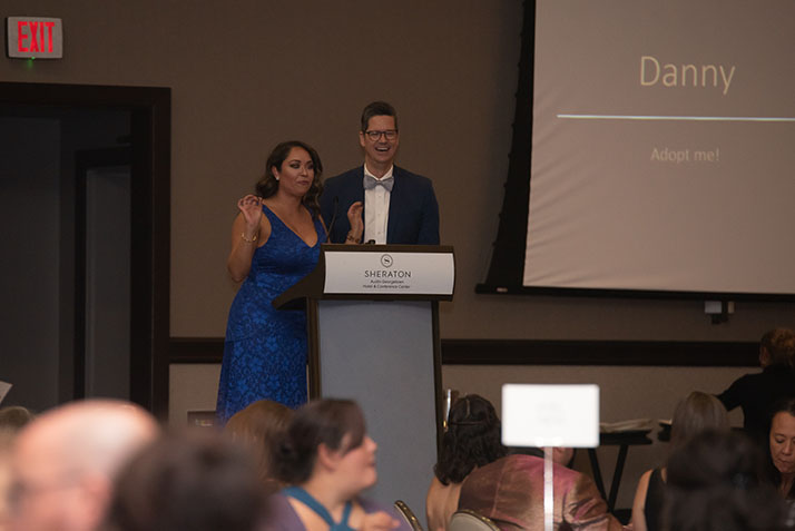 Co-Emcees on stage presenting at the event