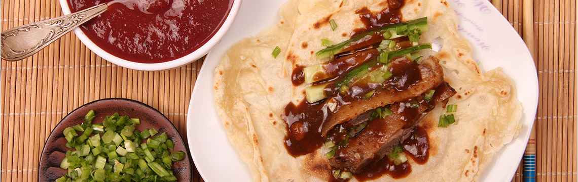 Crispy five spice scented, Peking Duck pancakes, hoisin sauce, Asian greens. image