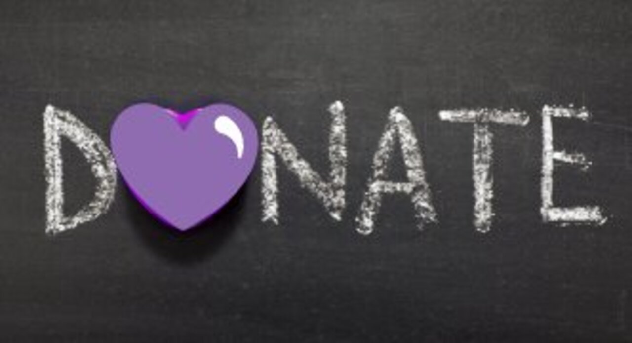 Image shows "donate " written in teal text against an orange button background. White cursor overlays the text. 