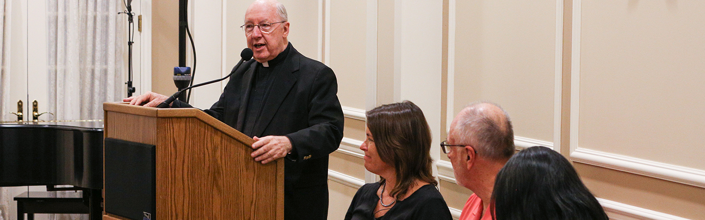 Panelists face the lectern during the event.