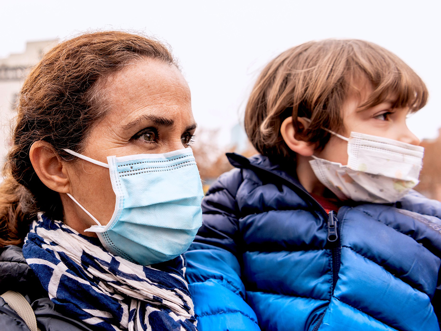 Woman with her son in a food bank line worried about loss of her job due to Covid-19