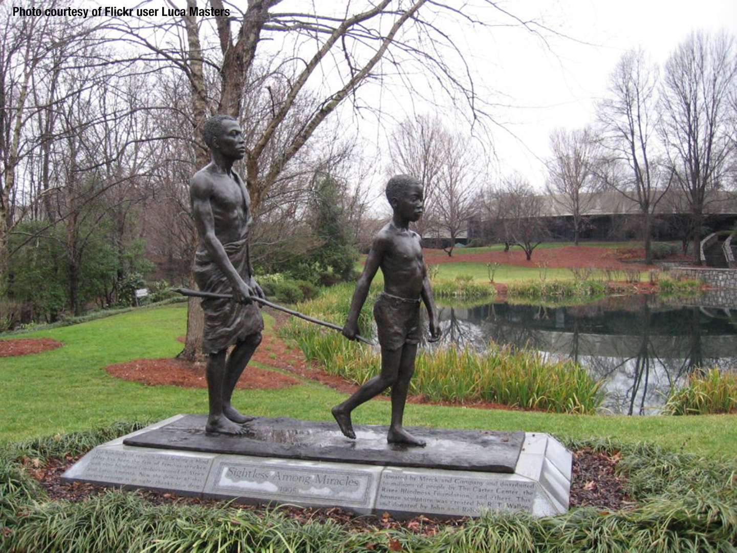 Statue of an African boy leading a blind man with a stick (courtesy of Flickr user Luca Masters)