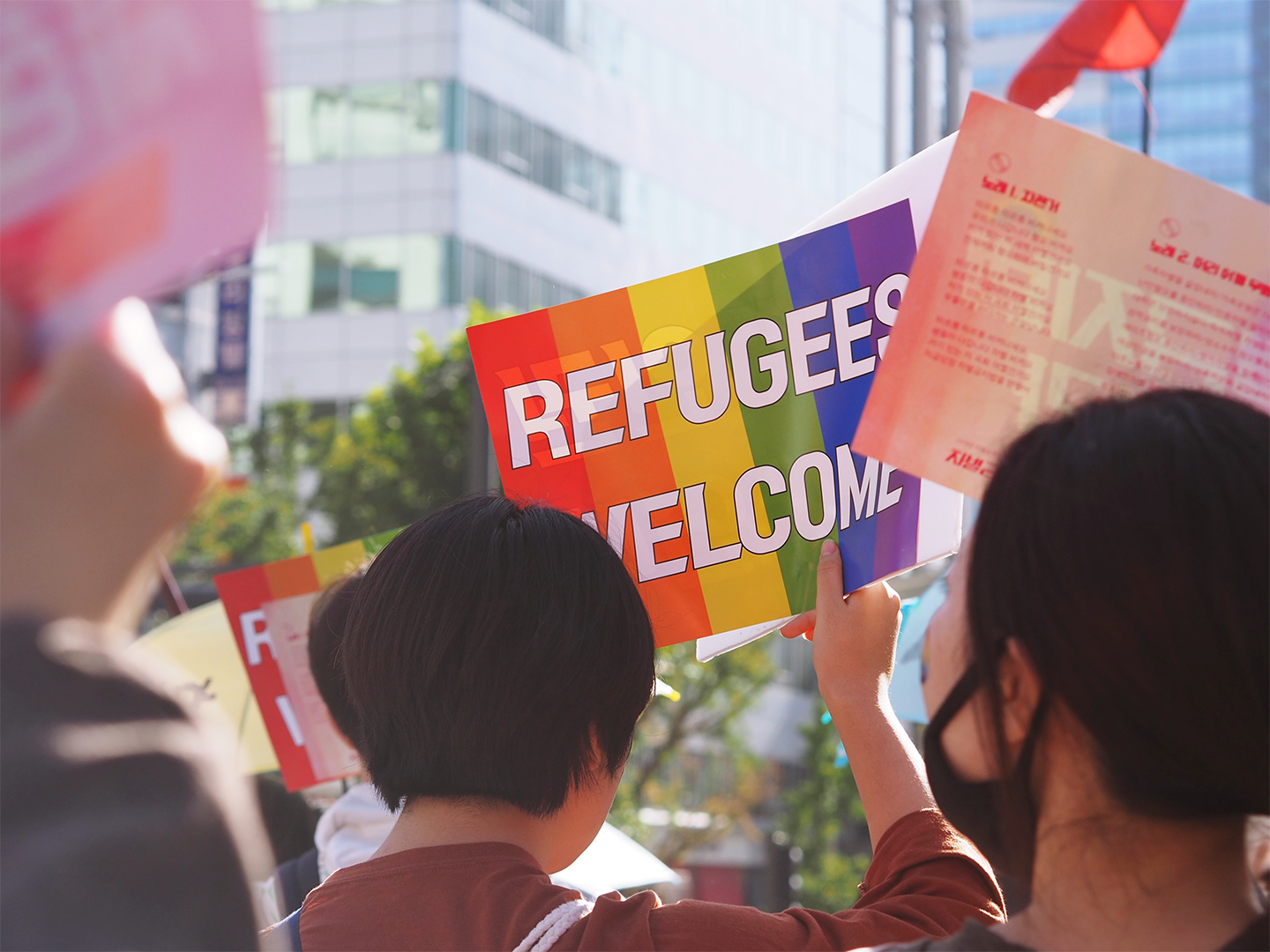 Protester sign that says "Refugees Welcome"