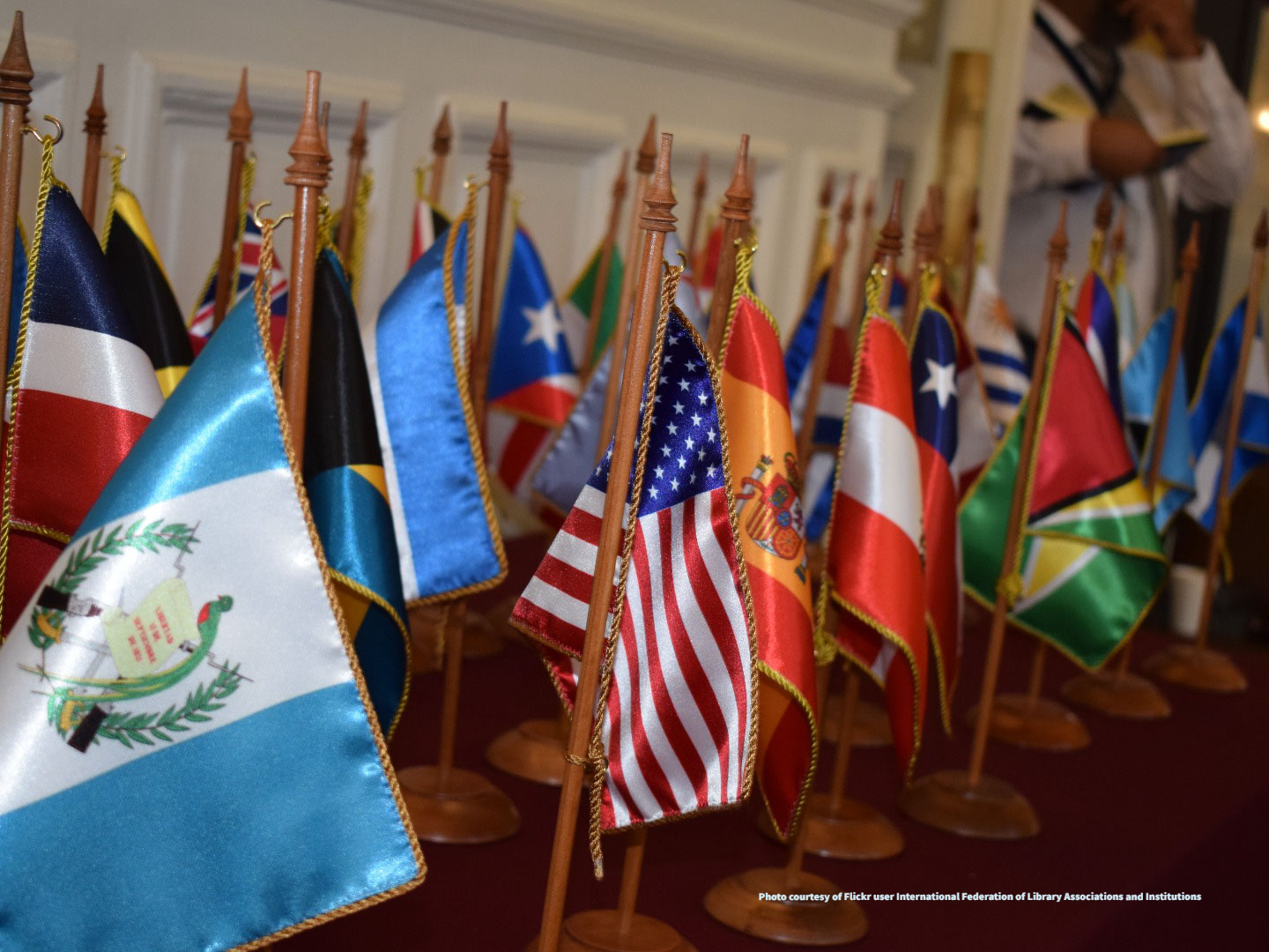 Flags of the Americas on a wooden table