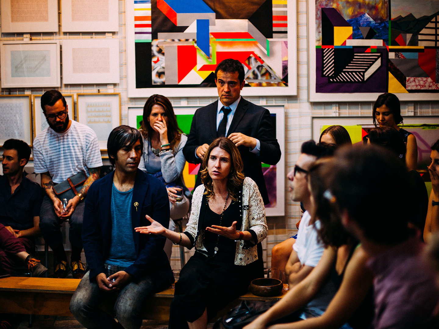 A woman talking in front of other people at a meeting