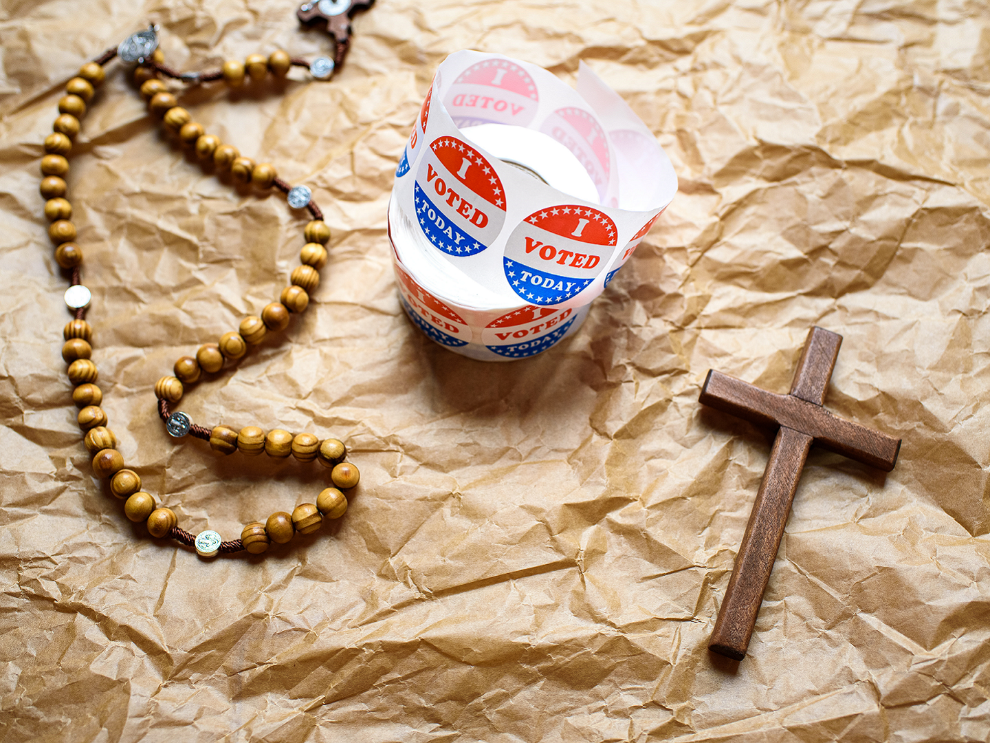 A rosary and an "I voted" sticker