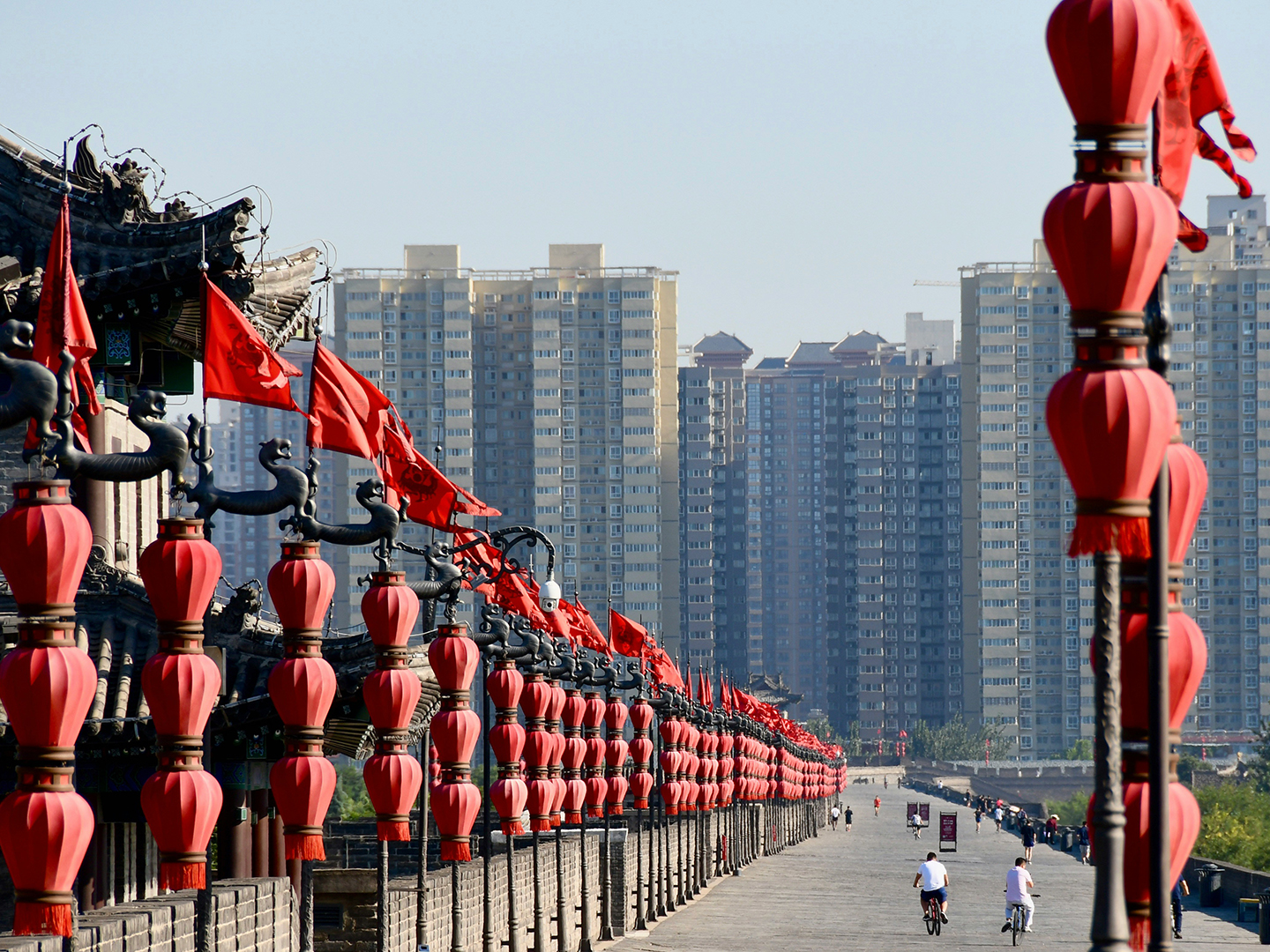 people-walking-on-street-near-high-rise-buildings-during-daytime-in-Xi'an
