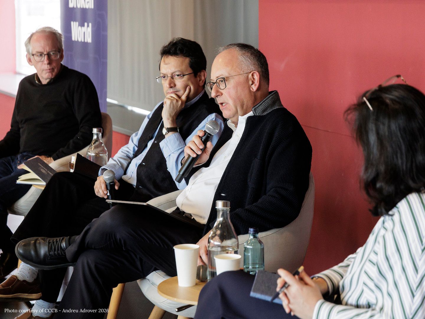 Paul Elie, Ranjit Hoskote, Rev. Antonio Spadaro, S.J., and Kamila Shamsie sit in chairs on a stage.