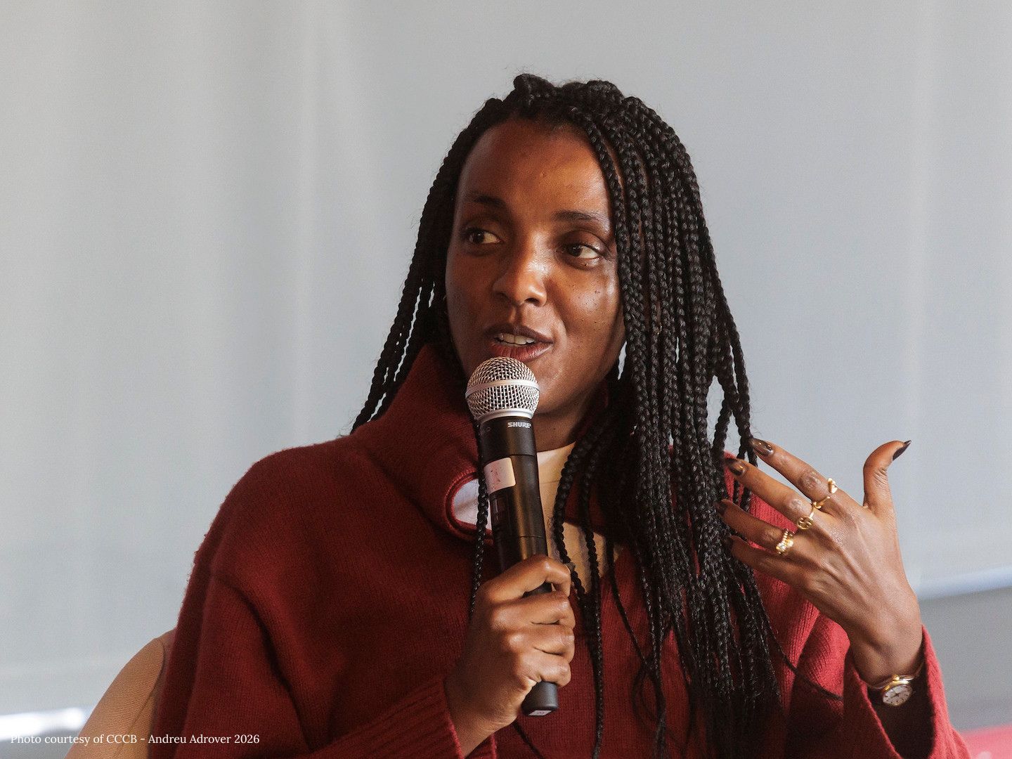 Nesrine Malik speaks into a microphone at the event