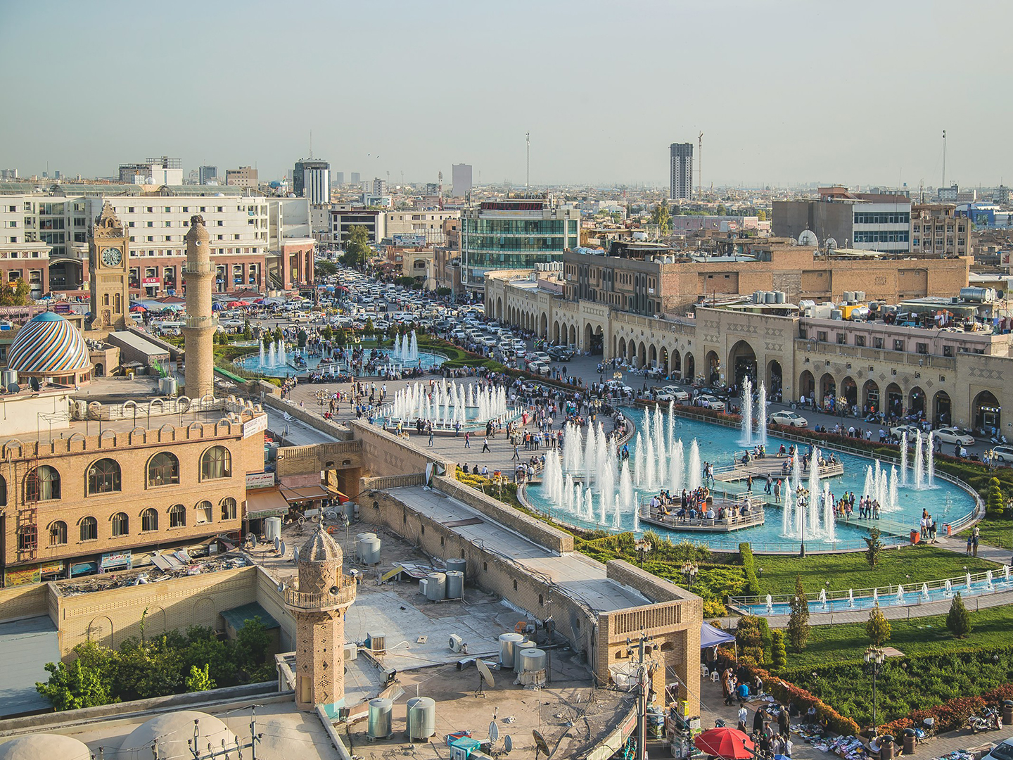 Fountains and a mosque in the center of a city in Iraq