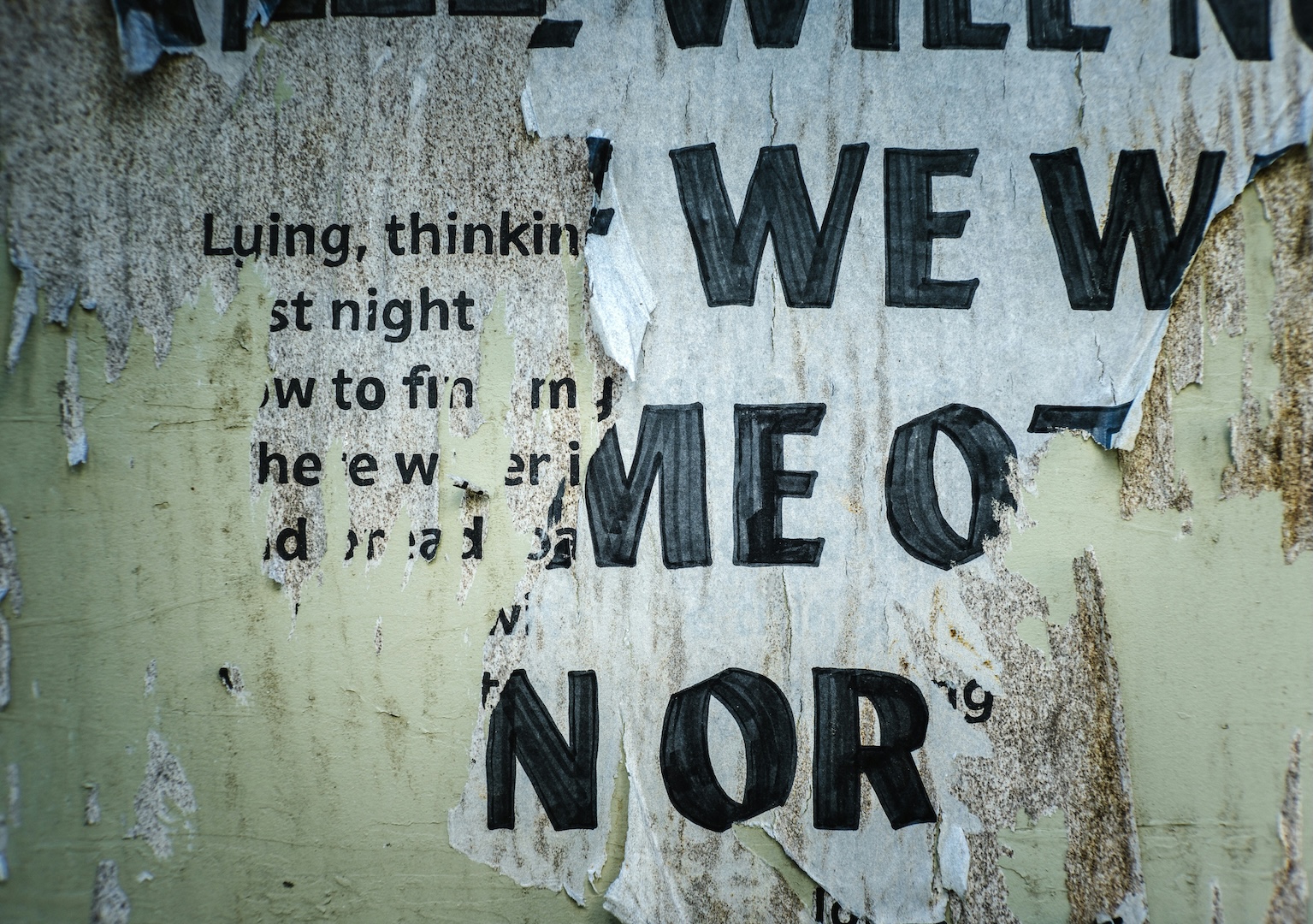 A torn poster on a wall