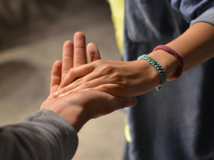 Two hands holding each other
