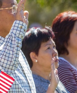 A group of people raising their right hand and taking an oath.