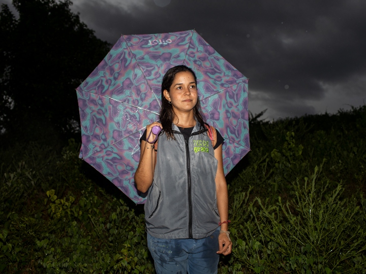 Jenifer Colpas con un paraguas en una de las comunidades con las que trabaja Tierra Grata