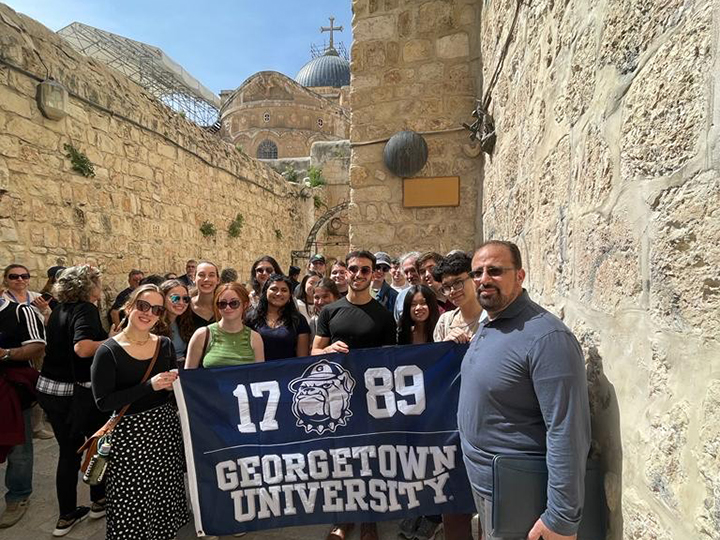 The Jerusalem and the Challenge of Peace class poses for a group picture outside the Church of the Holy Sepulchre