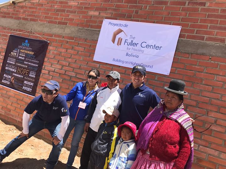 Fuller Center for Housing Bolivia staff, including Carlos Aramayo, stand with the beneficiary family