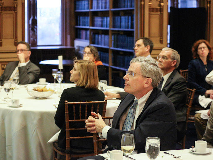 Guests watching presentation at Centenary Project dinner
