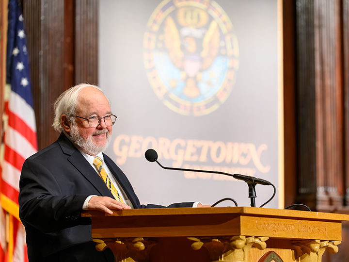 John Carr, founder of the Initiative on Catholic Social Thought and Public Life, welcomes the in-person and online audience to Gaston Hall