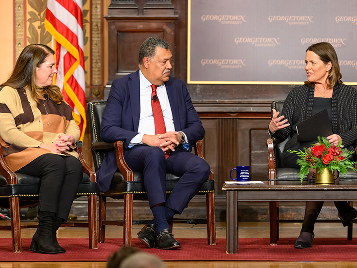 Kim Daniels (right), director of the Initiative on Catholic Social Thought and Public Life, asks a question to the panel