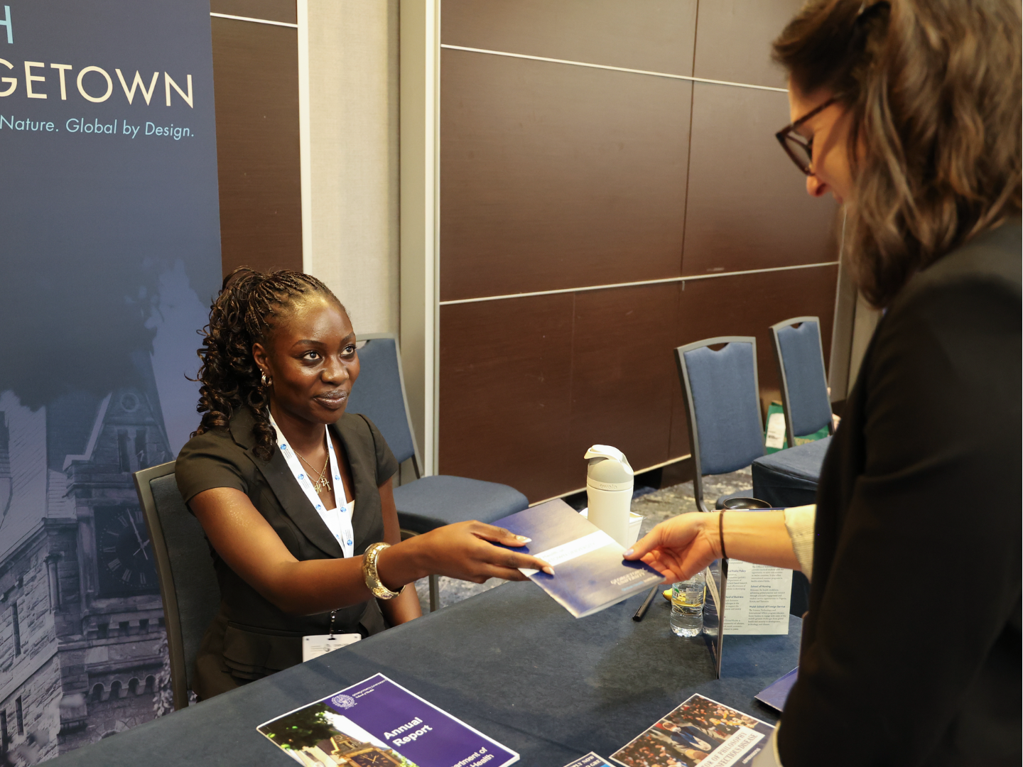 Undergraduate student and Global Health Fellow Kayla Wontuni (H27) engaged with conference attendees at Georgetown’s exhibitor table.
