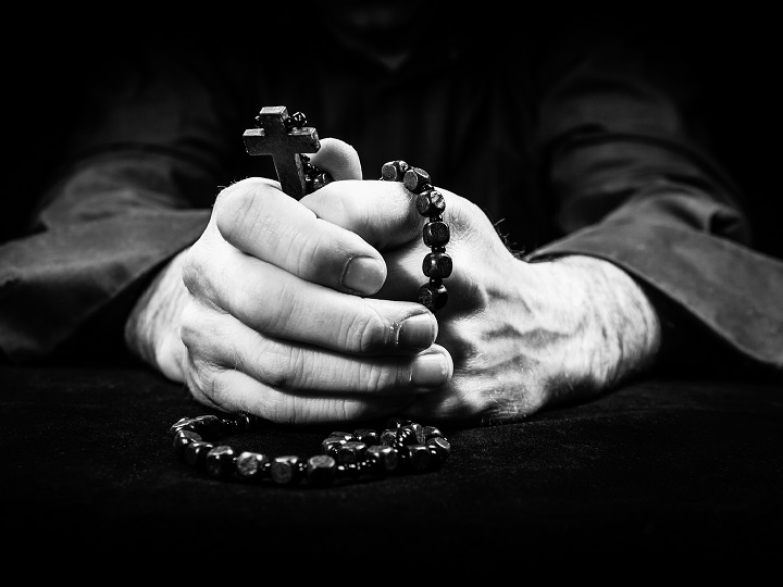 Hands holding rosary