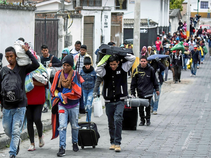 Venezuelan marching towards Peru through the streets of Tulcan. Ecuador, after crossing Colombia. LUIS ROBAYO AFP