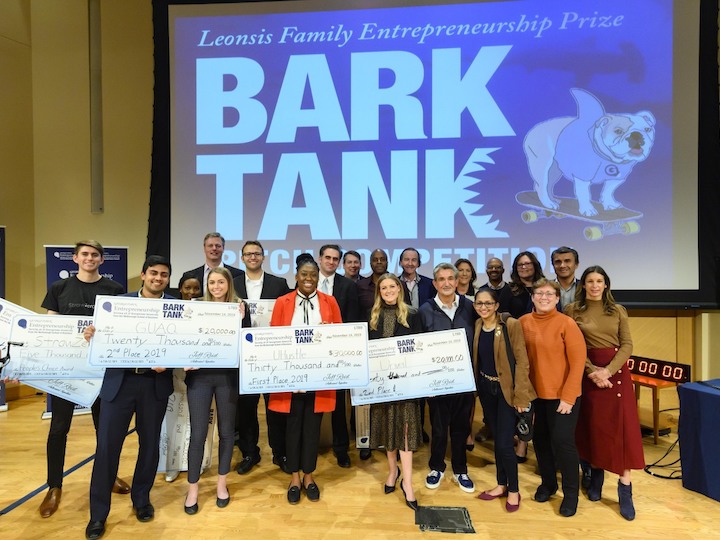 Students showcase their prize money won in the Leonsis Family Entrepreneurship competition.