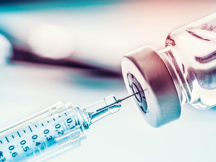 Syringe inserted into vial