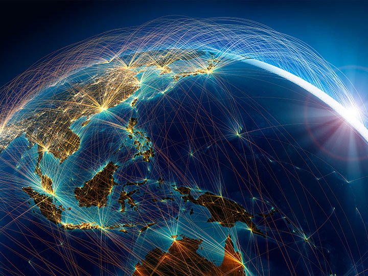 Globe focused on East Asia with network of lights connecting cities
